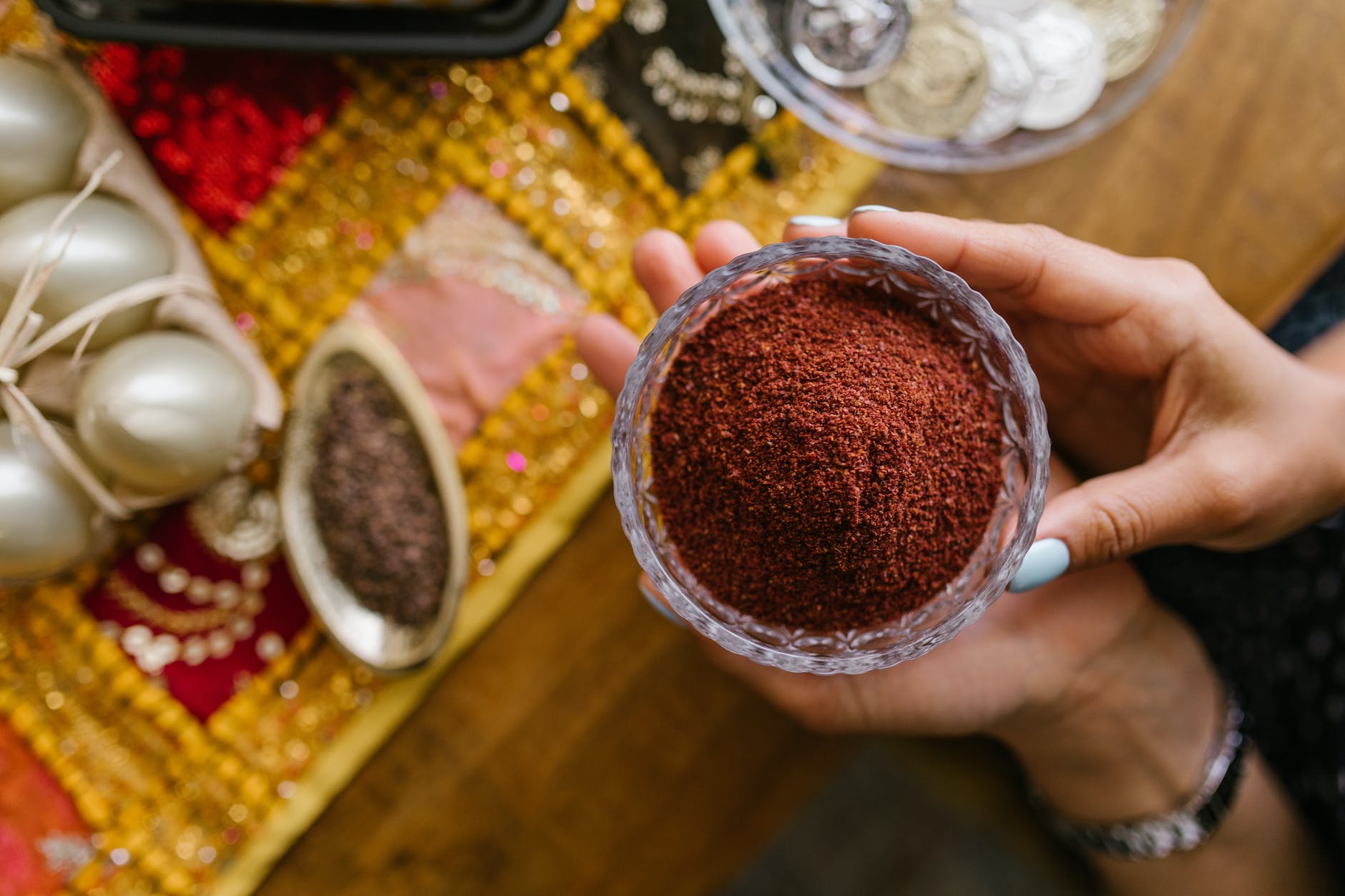 person holding a bowl of spice powder
